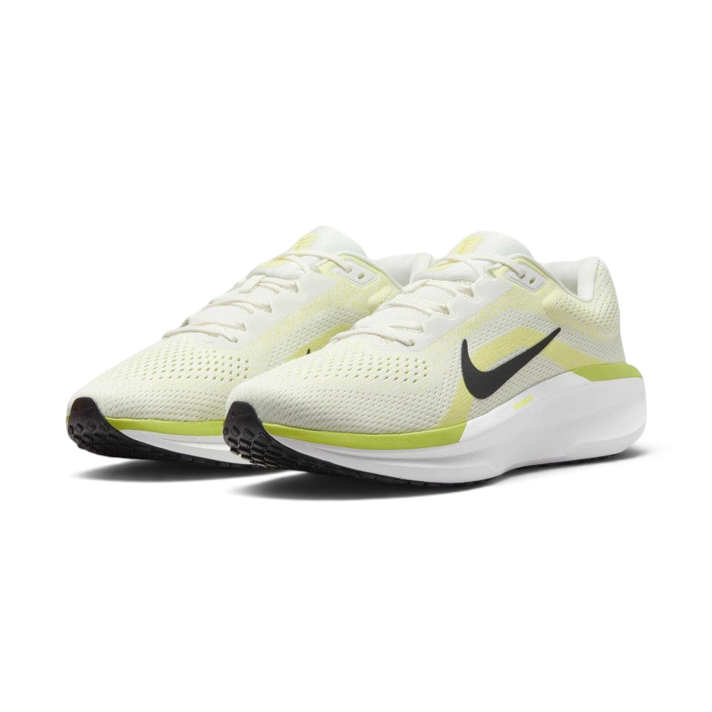Three-quarter front angle view showing both Nike Air Winflo 11 shoes side by side, showcasing their athletic running stance, off-white mesh uppers, and bright lime green highlights.