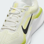Close-up detailed view of the midfoot section, showcasing the textured sail mesh upper, a clean black Swoosh, white laces, and "AIR" printed in yellow on the chunky white midsole.
