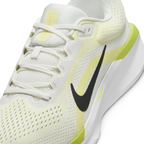 Close-up detailed view of the midfoot section, showcasing the textured sail mesh upper, a clean black Swoosh, white laces, and "AIR" printed in yellow on the chunky white midsole.