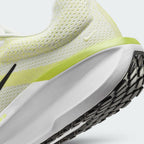 Close-up detailed view of the heel section, highlighting the breathable knit pattern, a tiny embroidered Swoosh, and the sleek junction where the lime green trim meets the sculpted white midsole.