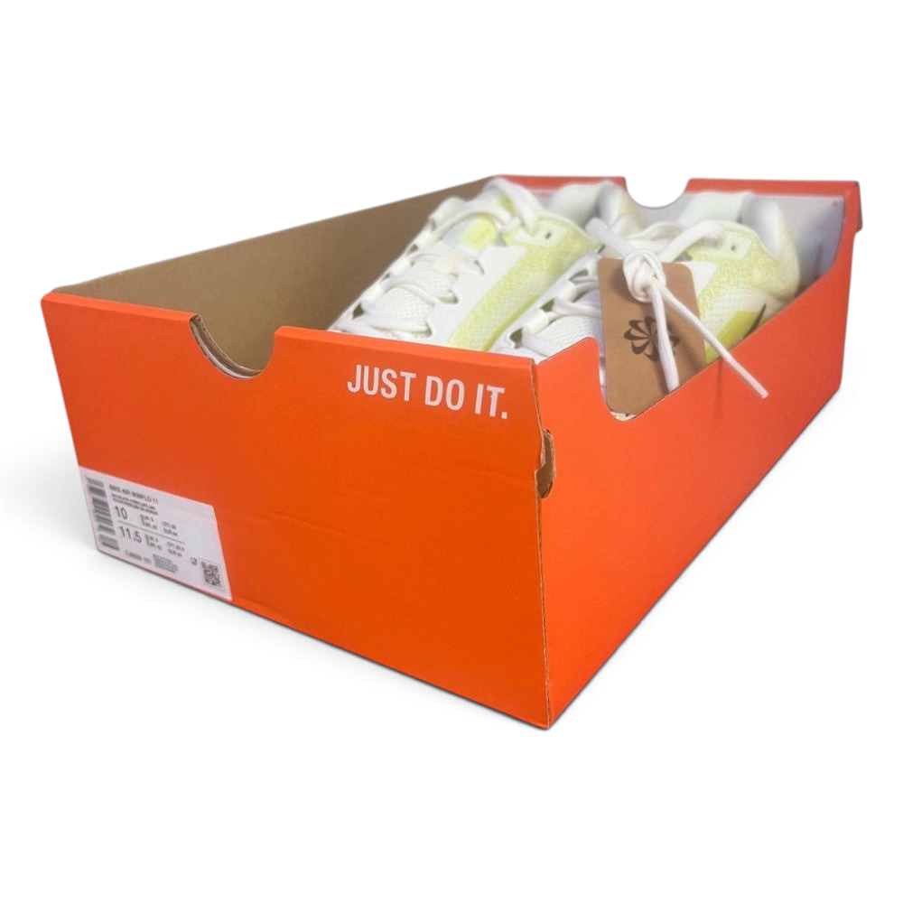 The Nike Air Winflo 11 shoes sitting inside an open orange Nike shoebox with no lid, displaying the classic slogan "JUST DO IT." in white on the side of the box and a circular-logo brown paper tag tied to the laces.