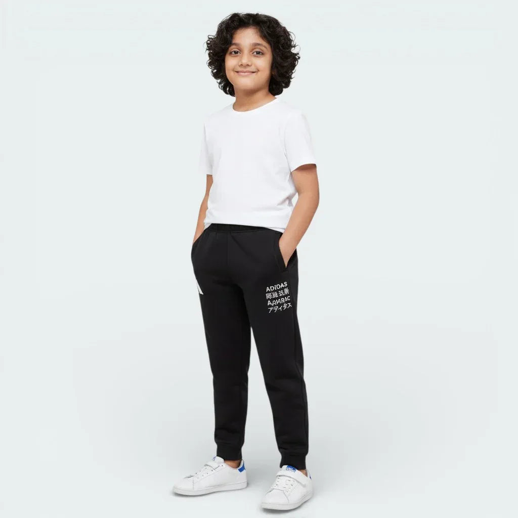Child wearing a white t-shirt and black pants with text on a white background Main image