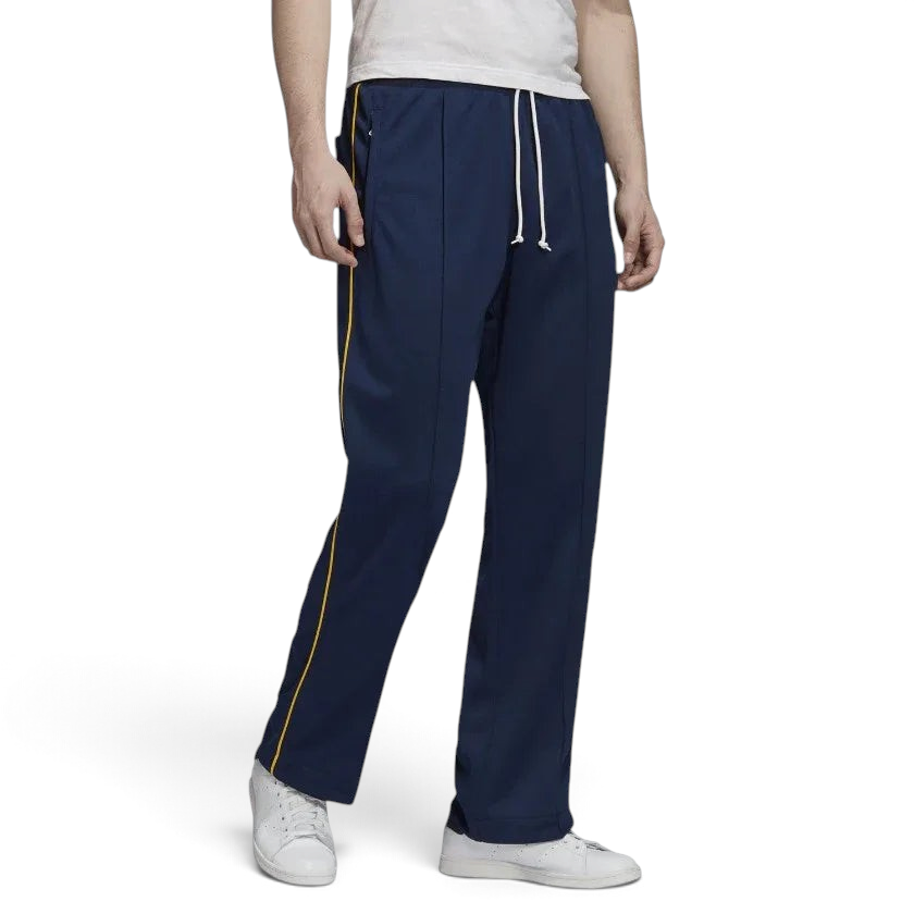 Adidas Recycled Track Pants Men's in dark blue, front view showing elastic waistband, drawcord, side pockets, and contrasting 3-Stripes down the legs.