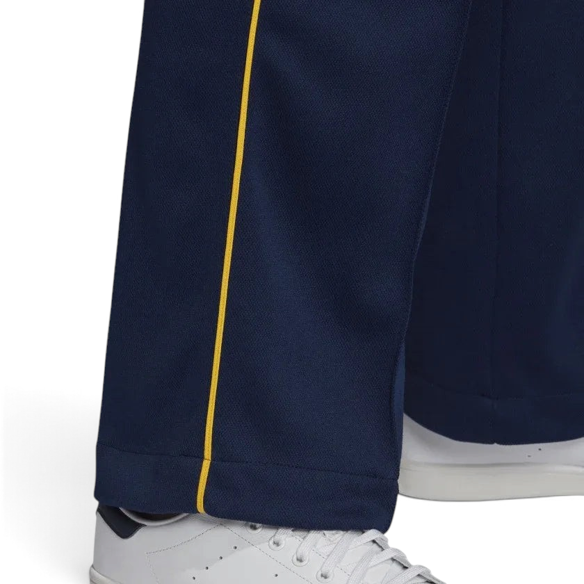 Close-up zoom on the Adidas Recycled Track Pants Men's in dark blue, showing the smooth fabric texture and the embroidered Adidas Trefoil logo.