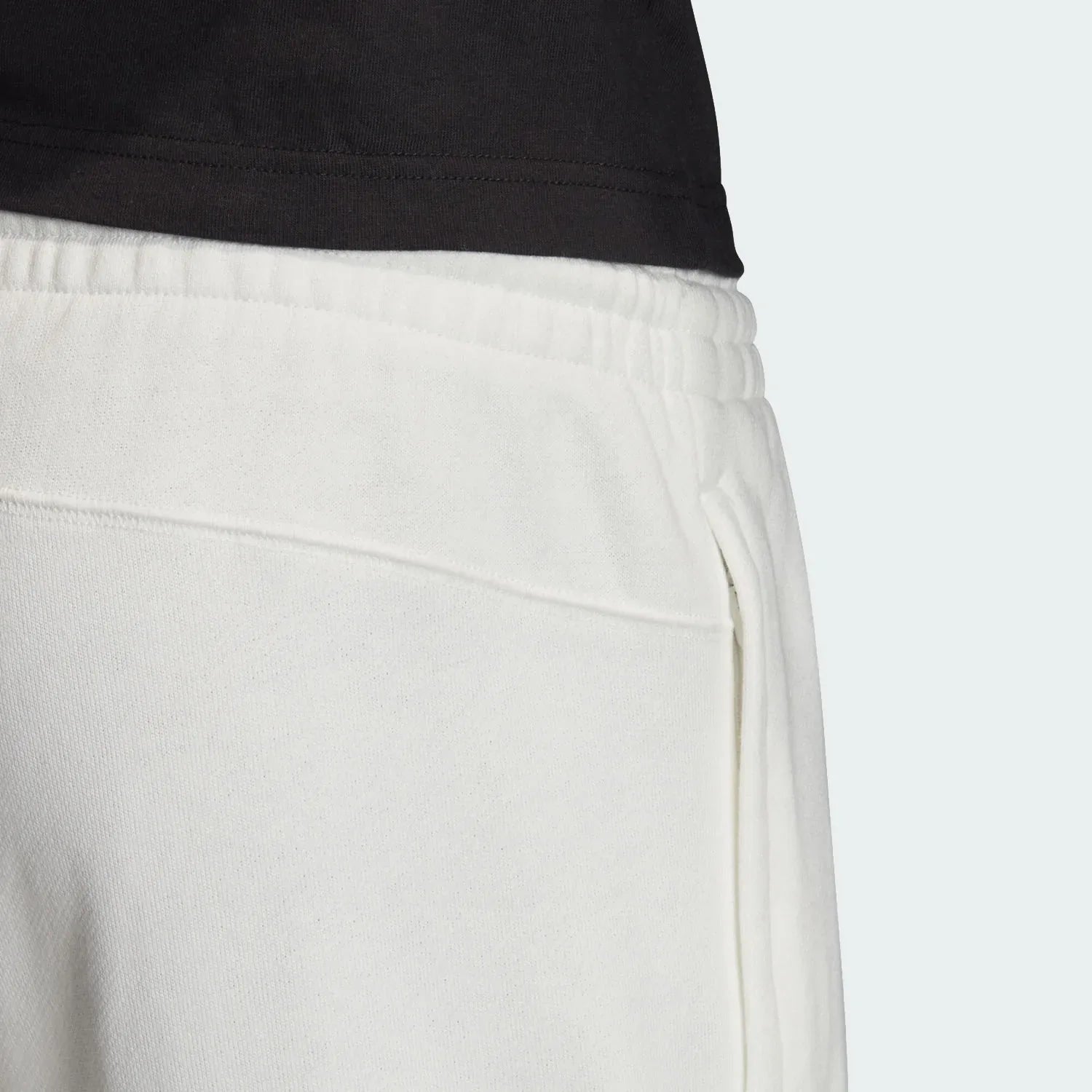 Focuses on the plush French terry interior and the crisp finish of the white cotton.