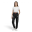 Person wearing a white crop top and black Adidas pants on a white background