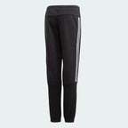 Black jogger pants with white stripes on a light gray background