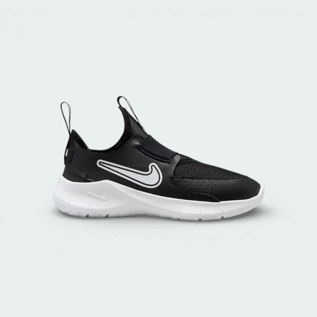 Nike Flex Runner infants slip-on trainers in black and white, side profile showing the stretchy mesh upper and thick white foam sole. Main image