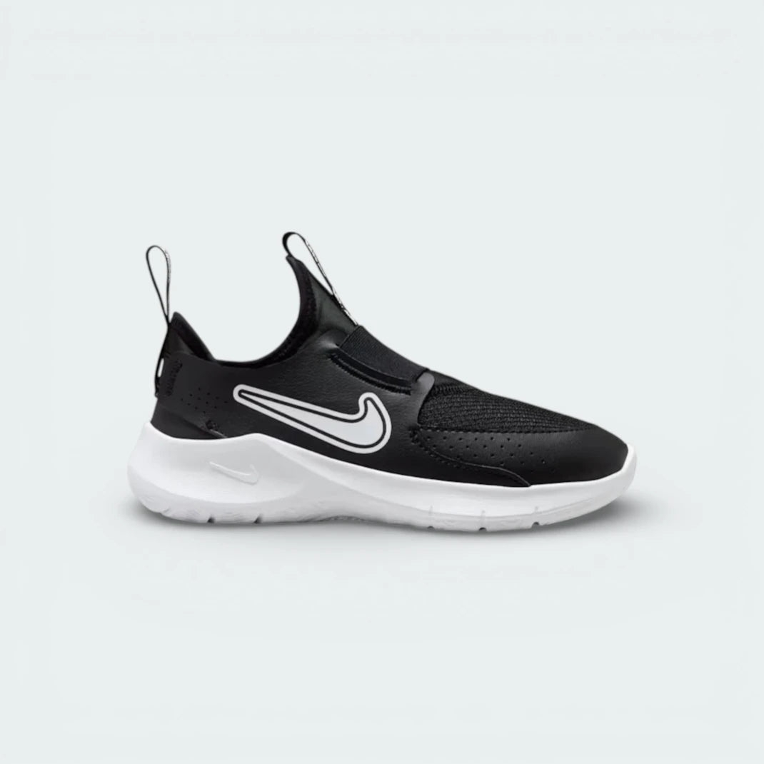 Nike Flex Runner infants slip-on trainers in black and white, side profile showing the stretchy mesh upper and thick white foam sole.