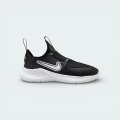 Nike Flex Runner infants slip-on trainers in black and white, side profile showing the stretchy mesh upper and thick white foam sole.