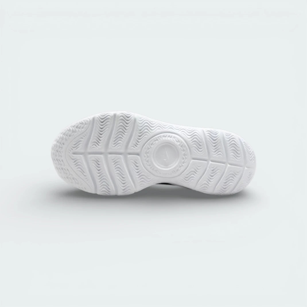 View of the white foam outsole, showing the deep flex grooves designed for natural movement.