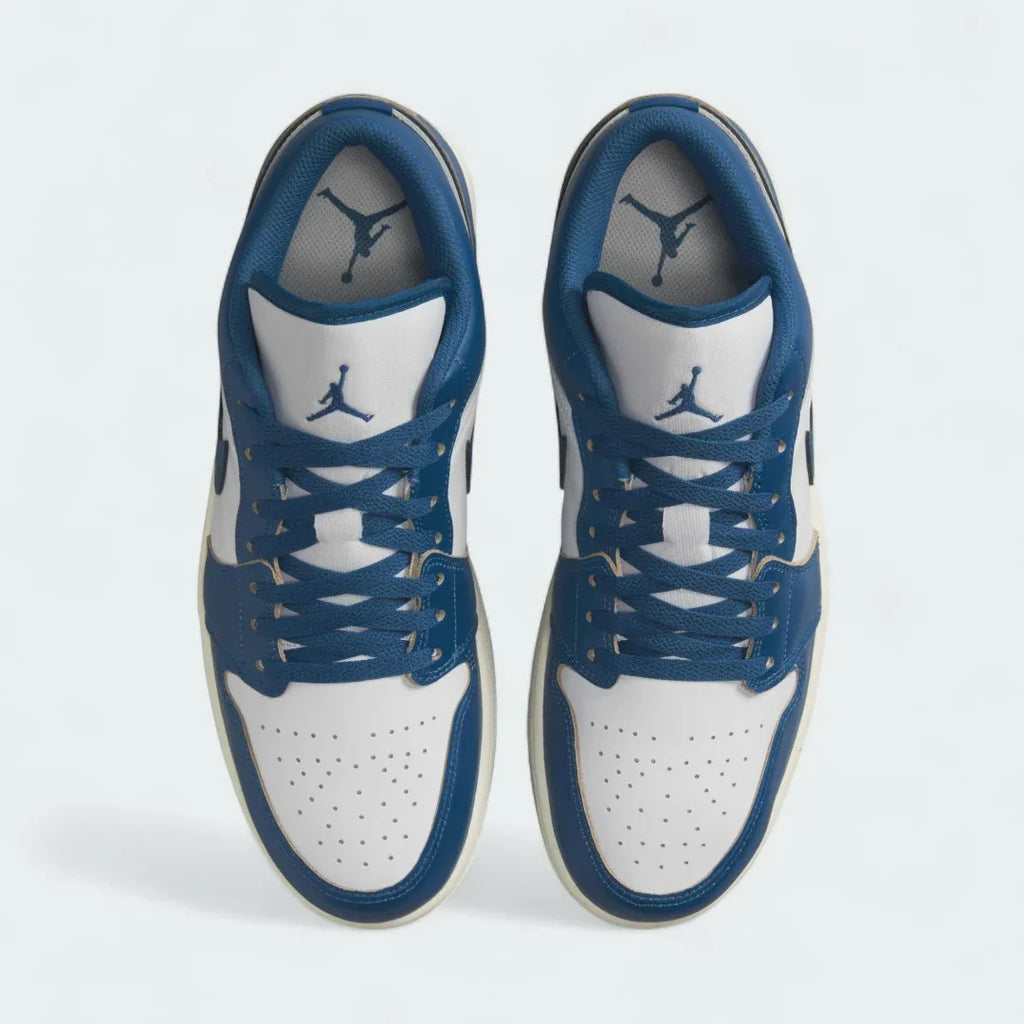Top-down view of a pair of Air Jordan 1 Low Special Edition Men's trainers in white, highlighting their iconic silhouette and lace-up closure.