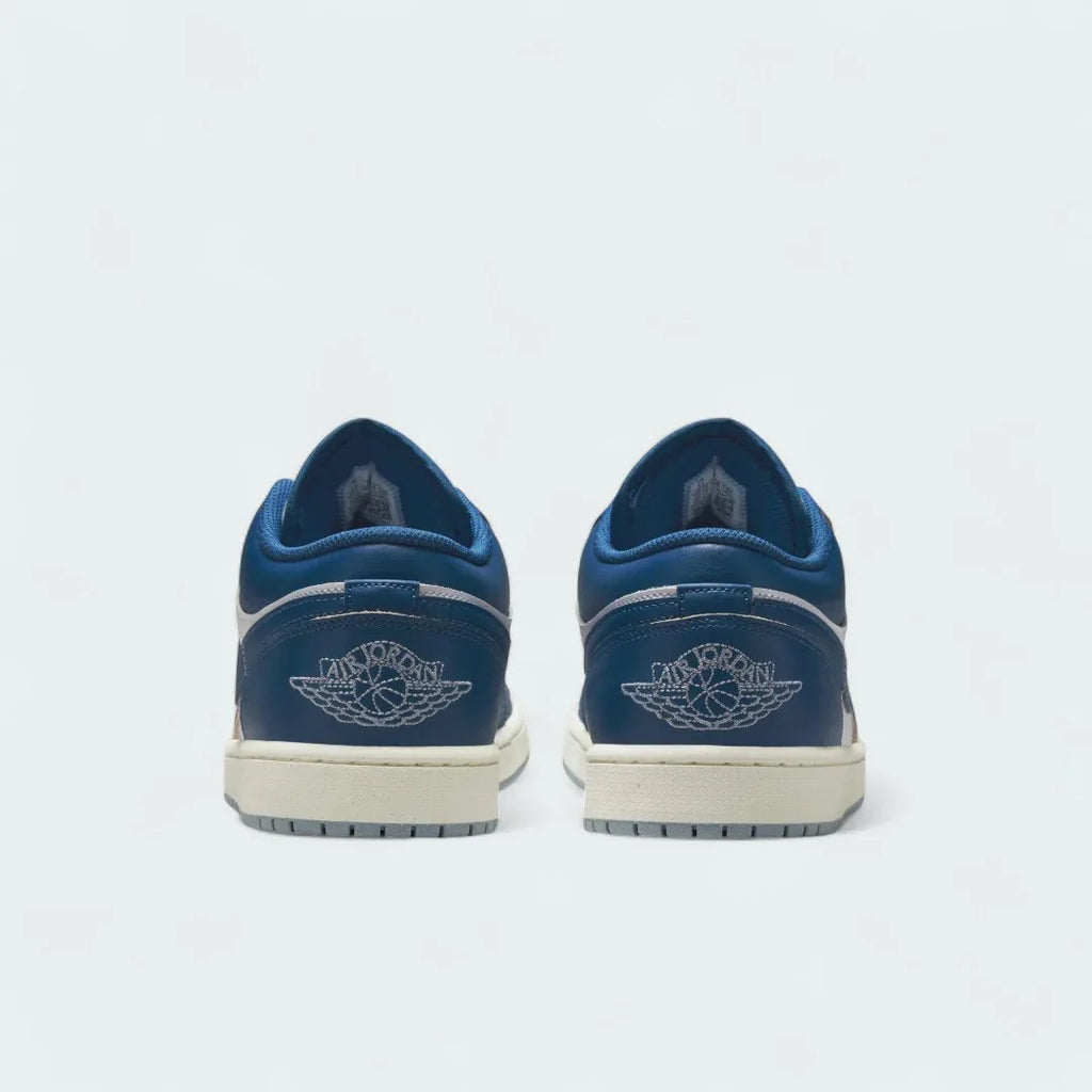 Rear view of the Air Jordan 1 Low Special Edition Men's white trainers, focusing on the Wings logo on the heel and contrasting heel panels.