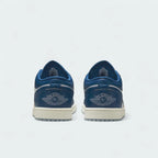 Rear view of the Air Jordan 1 Low Special Edition Men's white trainers, focusing on the Wings logo on the heel and contrasting heel panels.