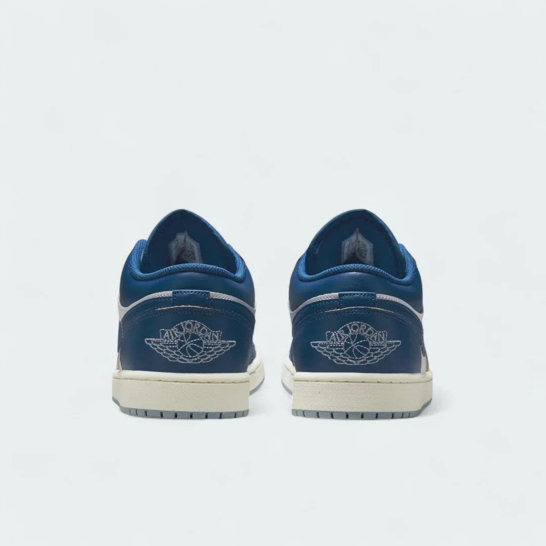 Rear view of the Air Jordan 1 Low Special Edition Men's white trainers, focusing on the Wings logo on the heel and contrasting heel panels.