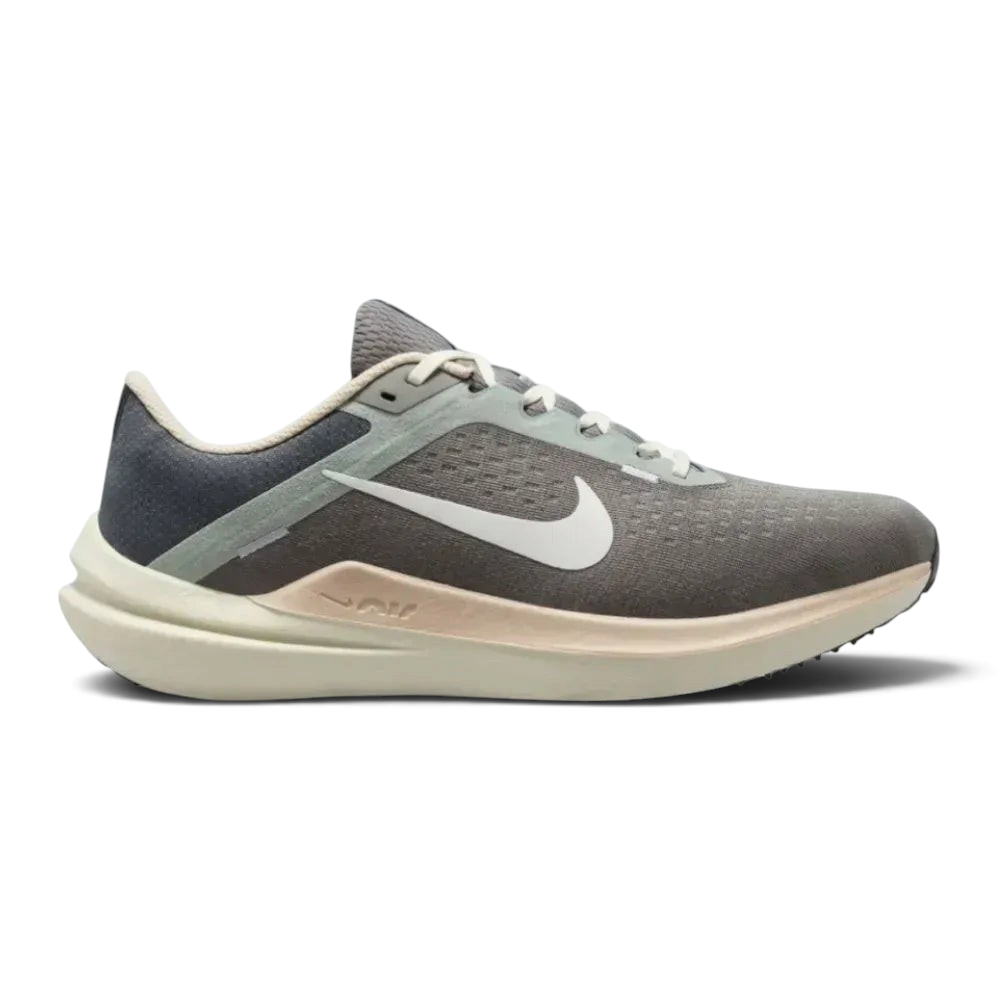 Side profile of the Nike Air Winflo 10 in Flat Pewter, showing the large white Swoosh, breathable engineered mesh, and the thick cushioned midsole.