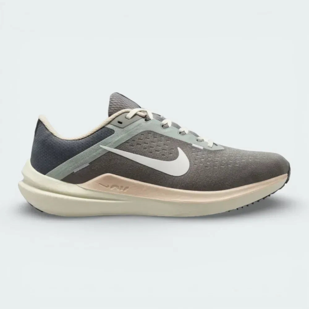 Side profile of the Nike Air Winflo 10 in Flat Pewter, showing the large white Swoosh, breathable engineered mesh, and the thick cushioned midsole.