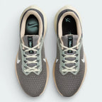 Top-down view of the grey and pewter trainers, highlighting the sleek lacing system and the fine texture of the engineered mesh toe box.