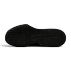 Displays the flat-profile geometric traction pattern of the solid black rubber sole, highlighting the deep forefoot flex grooves engineered for unreal lunge flexibility and premium mat grip.