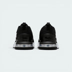 Focuses on the contoured shape of the robust rear heel structure, highlighting the wide, flared footprint engineered to distribute heavy workout loads evenly.