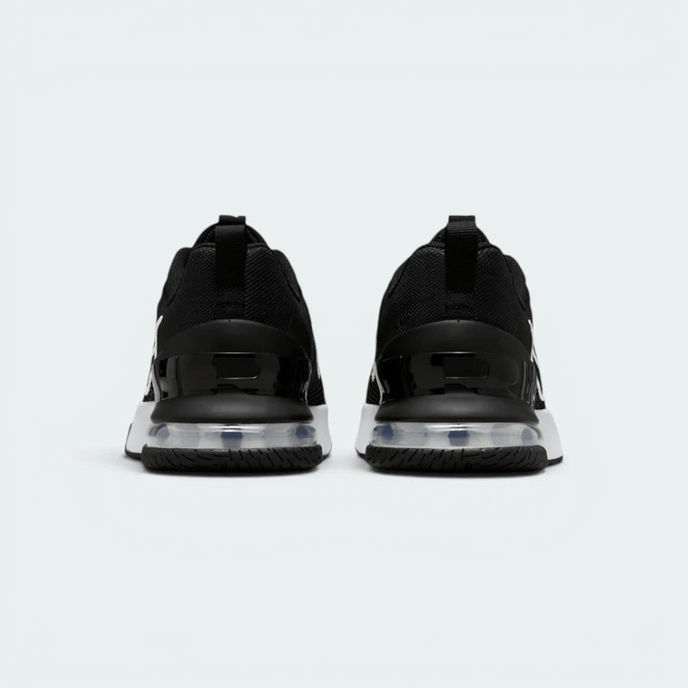 Focuses on the contoured shape of the robust rear heel structure, highlighting the wide, flared footprint engineered to distribute heavy workout loads evenly.
