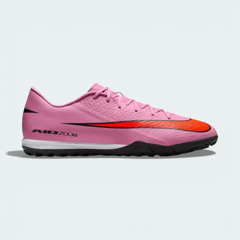 Side profile of the Magic Flamingo pink Nike Mercurial Vapor 16 Academy, showing the sleek NIKESKIN upper and the bold Total Crimson accents.