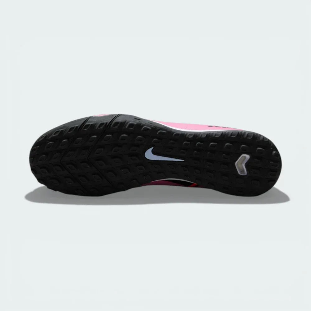 View of the lug rubber outsole, showcasing the aggressive traction pattern designed for stability on turf surfaces.