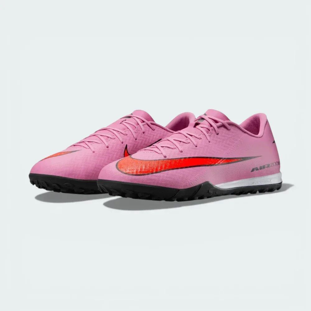 Three-quarter view of the pair, emphasizing the vibrant flamingo pink colourway and the responsive Air Zoom branding.
