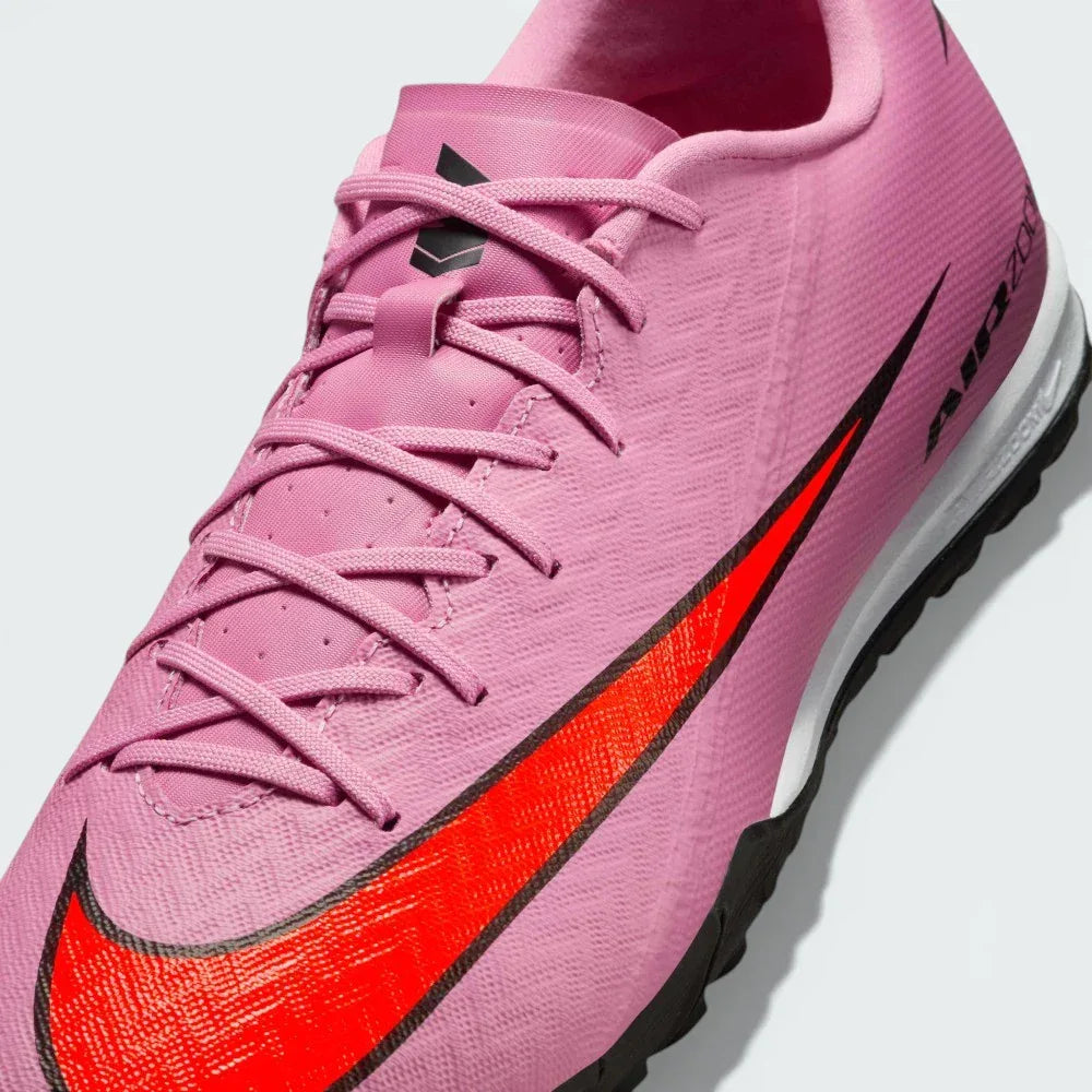 Close-up of the forefoot, focusing on the textured NIKESKIN pattern and the precision lacing system for a secure fit.