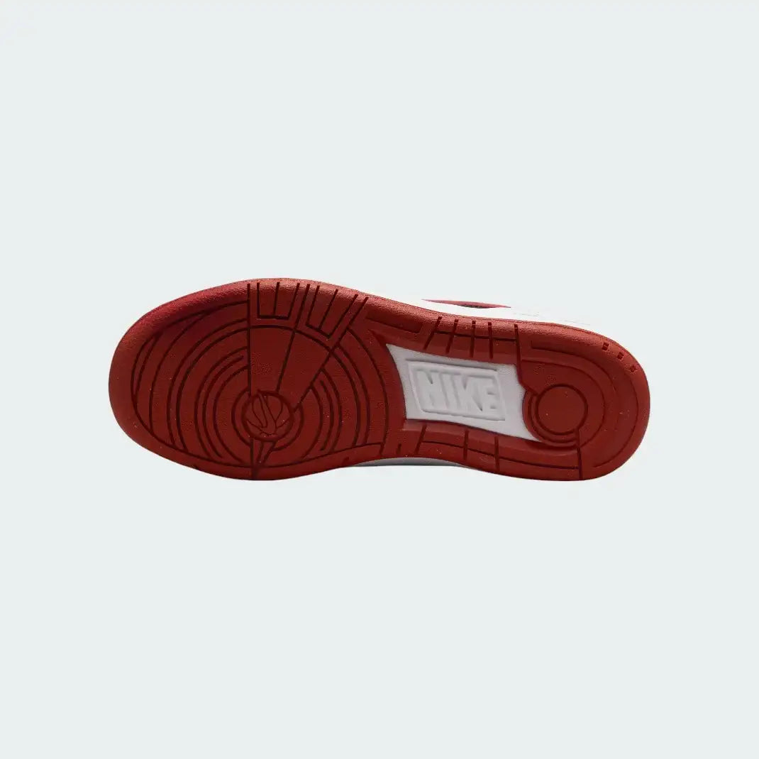 View of the outsole of the Nike Full Force Lo Juniors' white trainers, showing the durable rubber sole with multi-directional traction pattern.