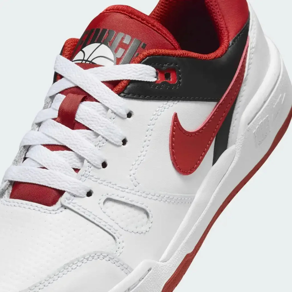 Close-up zoom on the front of the Nike Full Force Lo Juniors' trainers, showing the perforated toe box, lacing system, and layered leather texture.