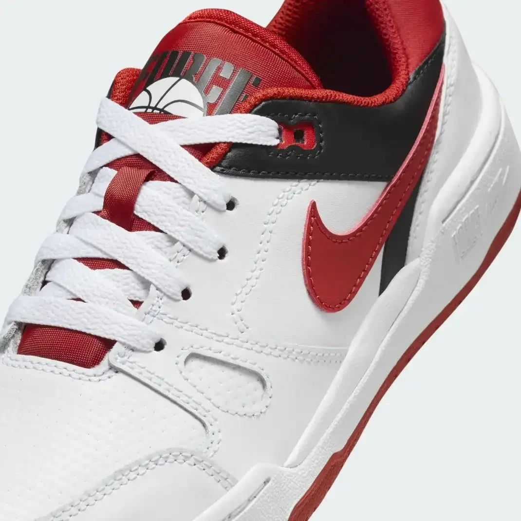 Close-up zoom on the front of the Nike Full Force Lo Juniors' trainers, showing the perforated toe box, lacing system, and layered leather texture.