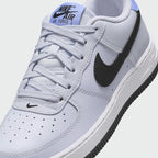 Close-up of Nike Air Force 1 Juniors Grey Trainers FV5948-003 smooth leather texture, laces, and tongue label