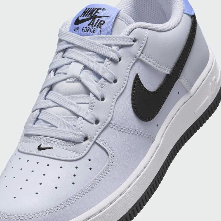 Close-up of Nike Air Force 1 Juniors Grey Trainers FV5948-003 smooth leather texture, laces, and tongue label