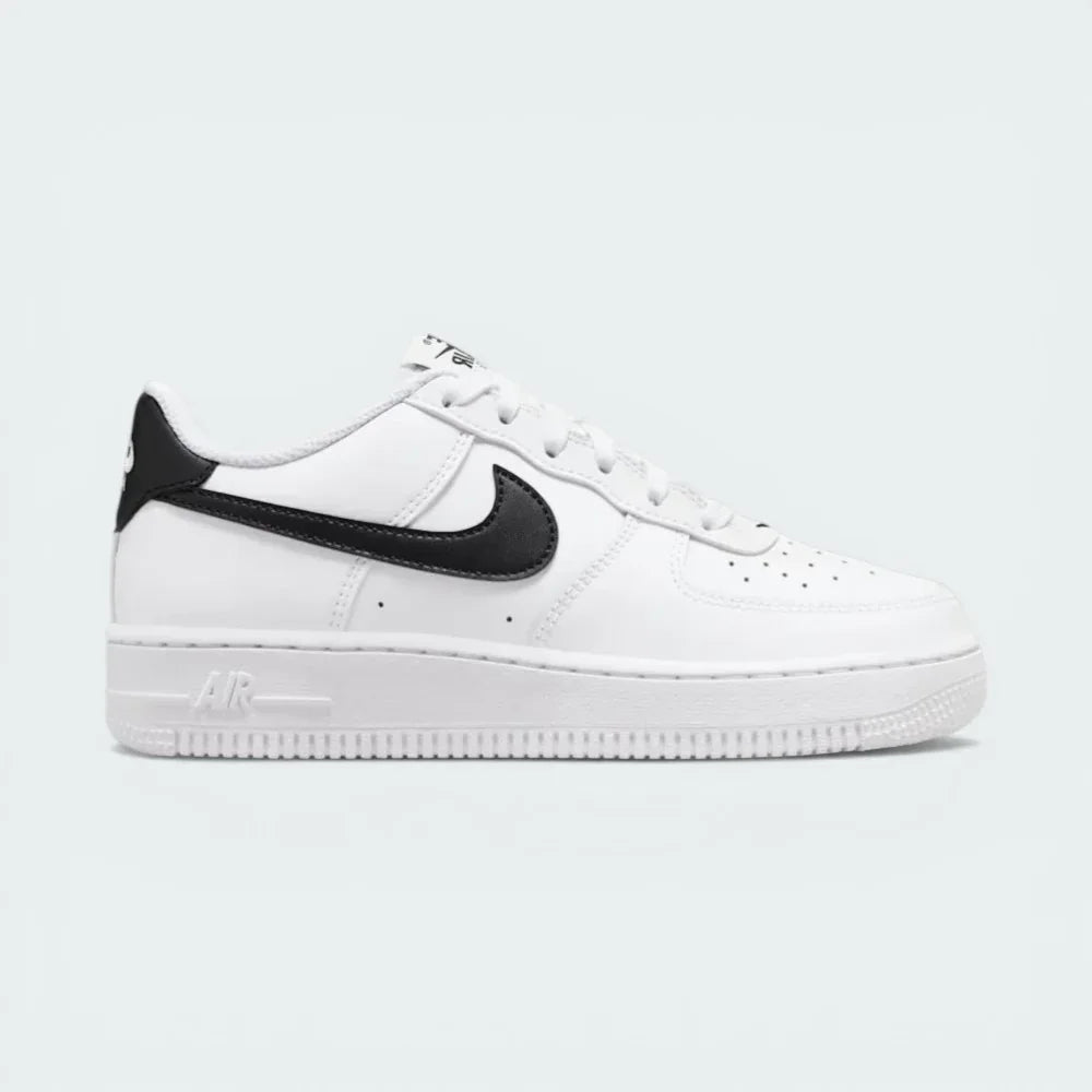 Side profile of the White/Black Nike Air Force 1 Junior, showcasing the bold black Swoosh against the crisp white leather. Main image