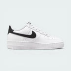 White sneaker with black Nike logo on a light gray background