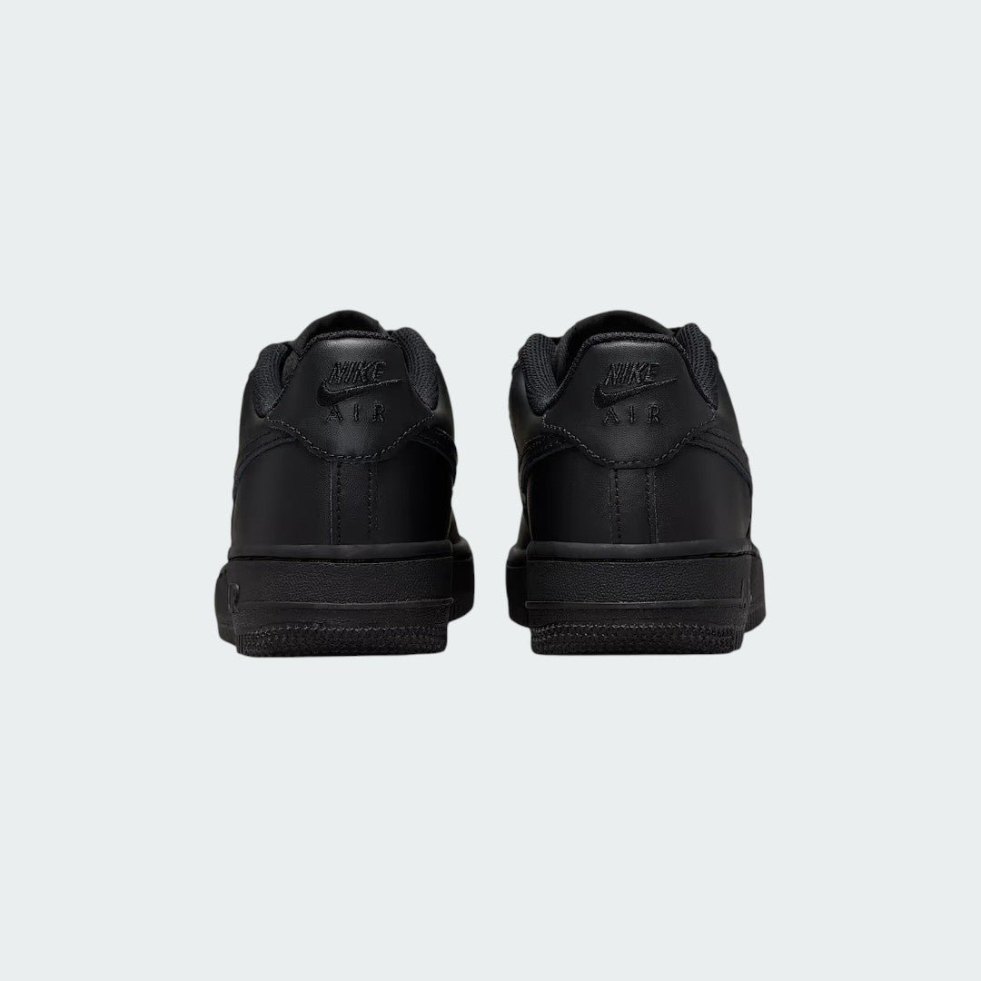 Rear view of the Nike Air Force 1 Juniors' black trainers, focusing on the heel panel and Nike Air branding.