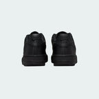 Rear view of the Nike Air Force 1 Juniors' black trainers, focusing on the heel panel and Nike Air branding.