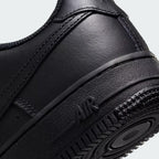 Detailed zoom on the outsole and midsole of the Nike Air Force 1 Juniors' black trainers, highlighting the cushioned midsole and durable rubber outsole.