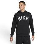Studio front three-quarter view of a male model wearing the black Nike Swoosh Dri-FIT pullover hoodie, highlighting the distressed white arched "NIKE" chest graphic, matching black drawstrings, and the front kangaroo pocket.