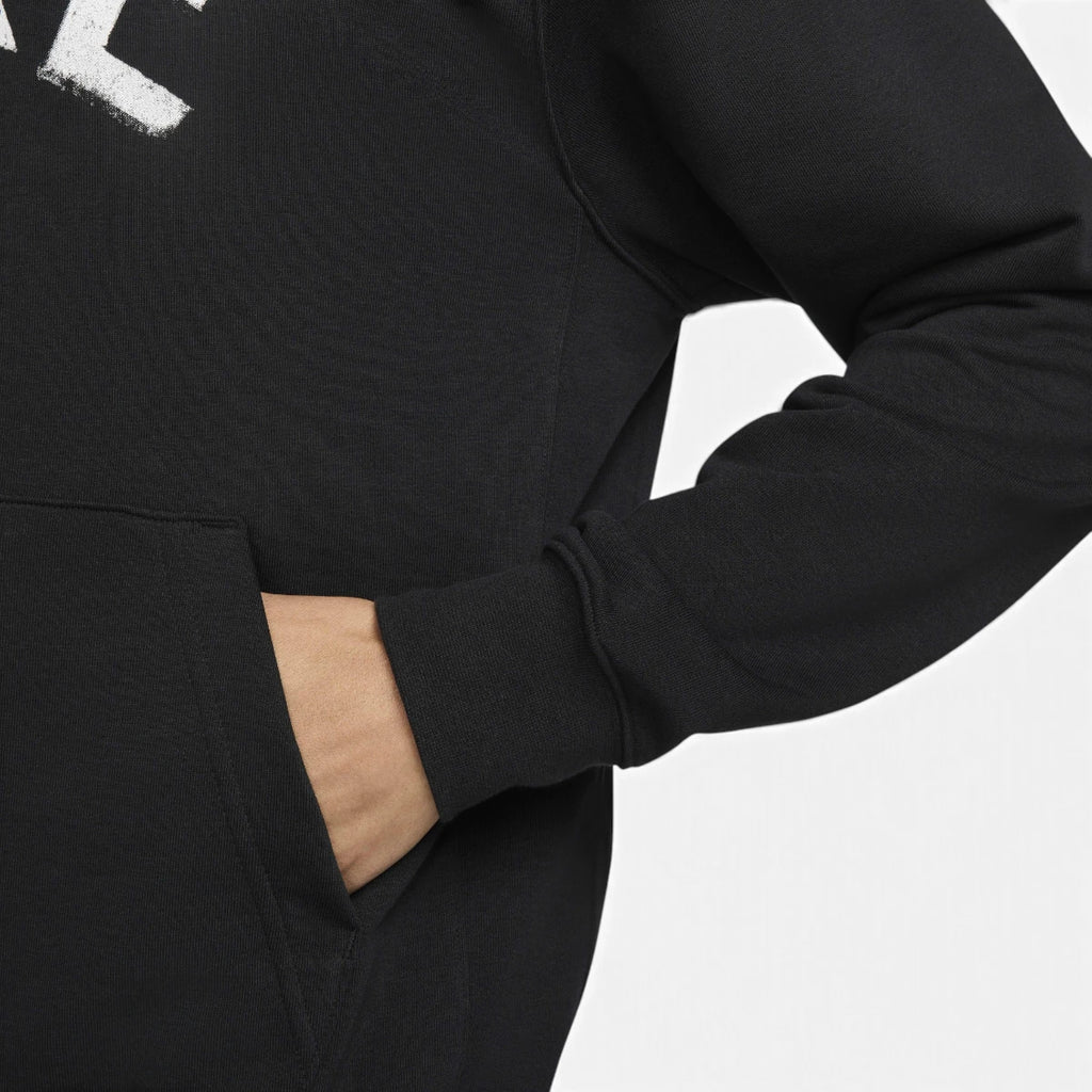 Macro studio close-up focusing on the side entry of the front kangaroo pocket, the fine-grained texture of the midweight French terry fabric, and the elasticated ribbed cuff.