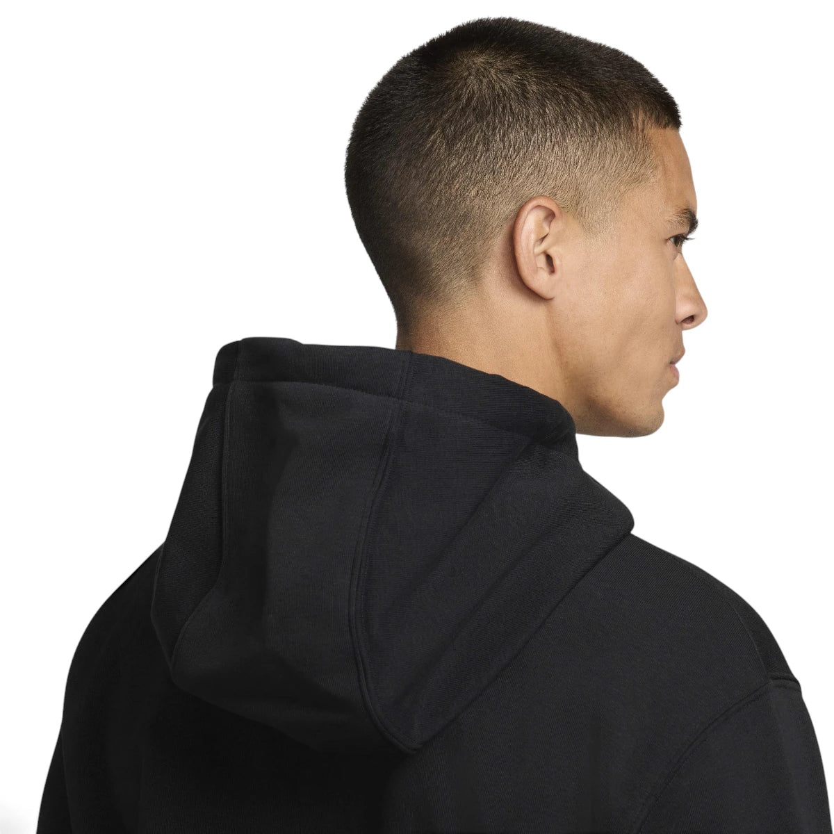 Close-up profile view focusing on the soft-lined hood construction, clean collar binding, and smooth structure of the black fabric.