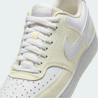 Close-up zoom on the front of the Nike Court Vision Lo Next Nature Women's white trainers, showing the perforated toe box, lacing system, and texture of the upper materials.