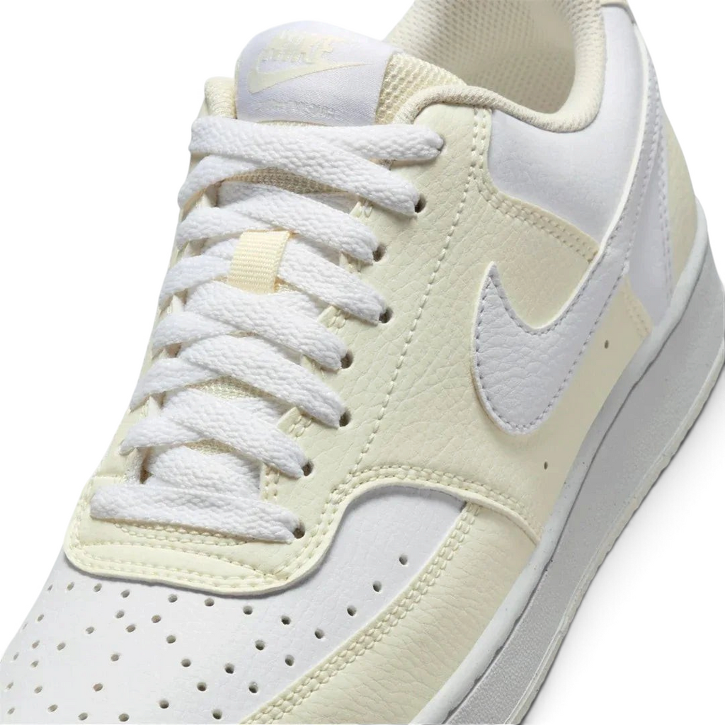 Close-up zoom on the front of the Nike Court Vision Lo Next Nature Women's white trainers, showing the perforated toe box, lacing system, and texture of the upper materials.