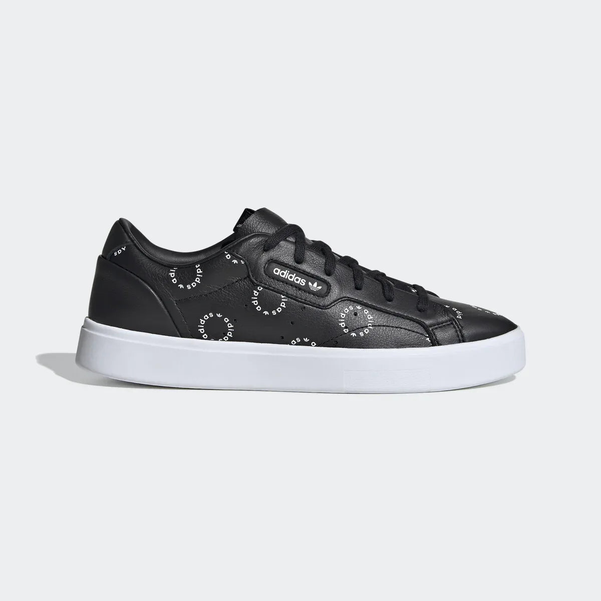 Adidas Originals Sleek Women's trainers in white, side profile showing the all-over black monogram Trefoil logo print on the leather upper. Main image