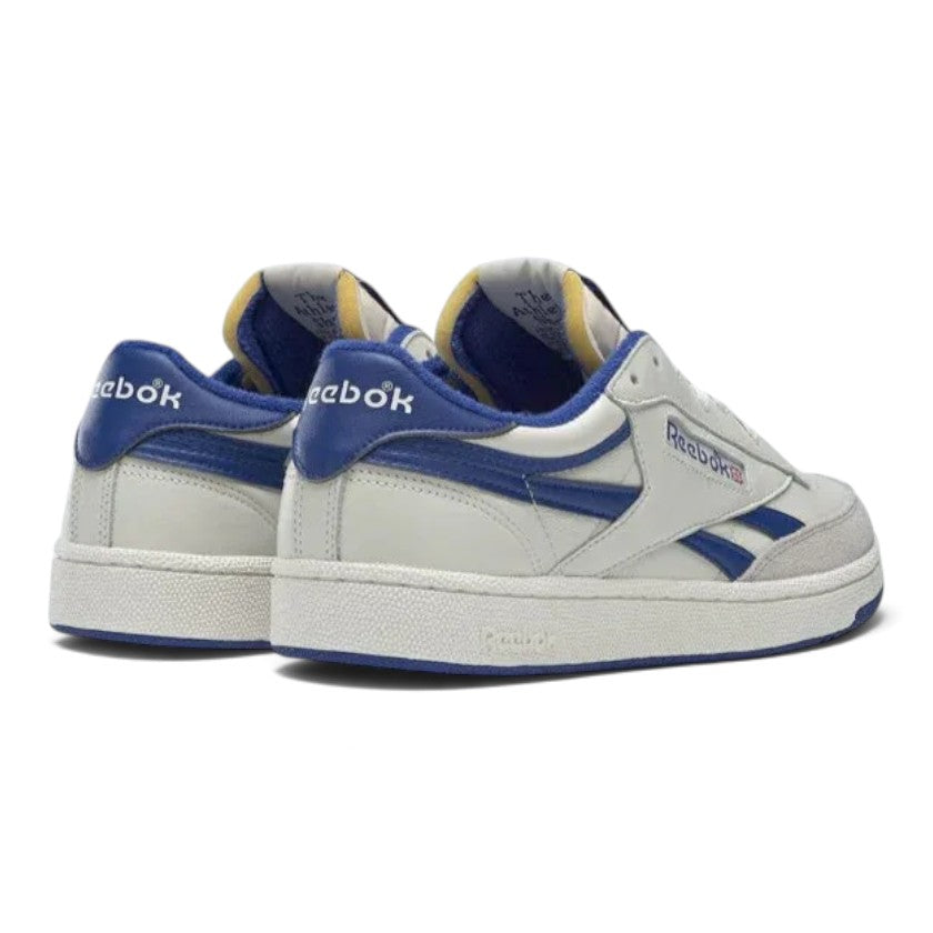 Rear angle view focusing on the padded royal blue heel collars and heel tabs with white Reebok branding, off-white stitched cupsole midsoles, and blue rubber outsoles.