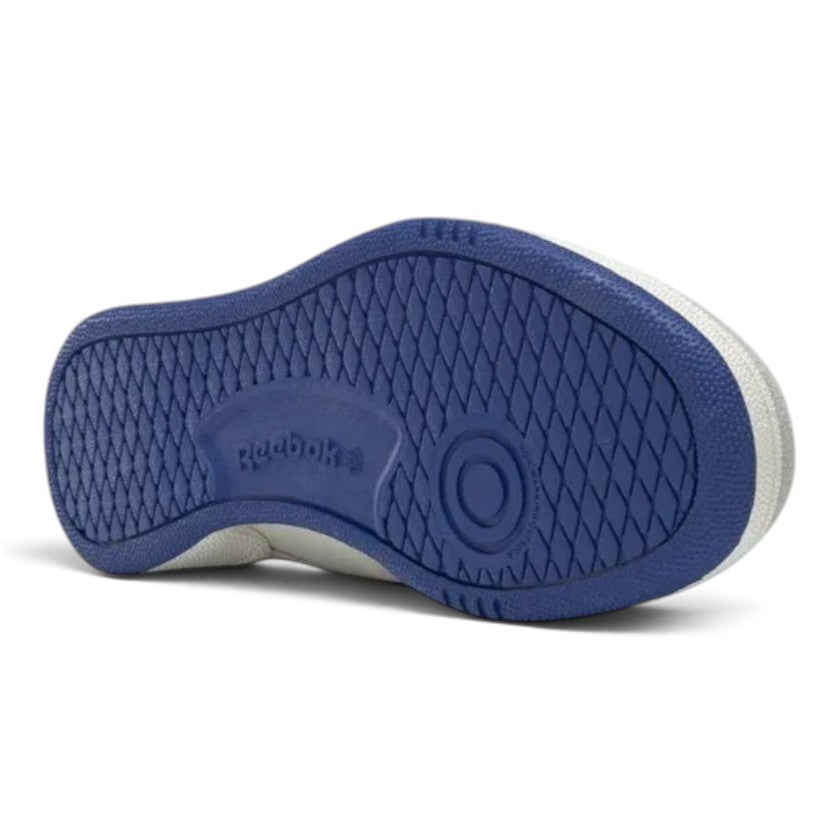 Full underside view of the collegiate royal blue rubber outsole displaying the classic multi-directional herringbone tread pattern, pivot circle, and embossed Reebok logo.