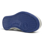 Full underside view of the collegiate royal blue rubber outsole displaying the classic multi-directional herringbone tread pattern, pivot circle, and embossed Reebok logo.