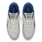Overhead top-down view of both sneakers side by side, featuring the white lace-up closure, perforated toe vamps, exposed foam tongue construction with vintage woven labels, and plush royal blue terry cloth linings.