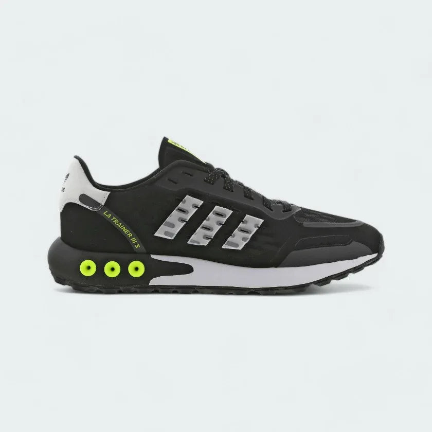 Side Profile Image: Highlights the fluorescent yellow midsole pegs and the perforated black side panels. Main image